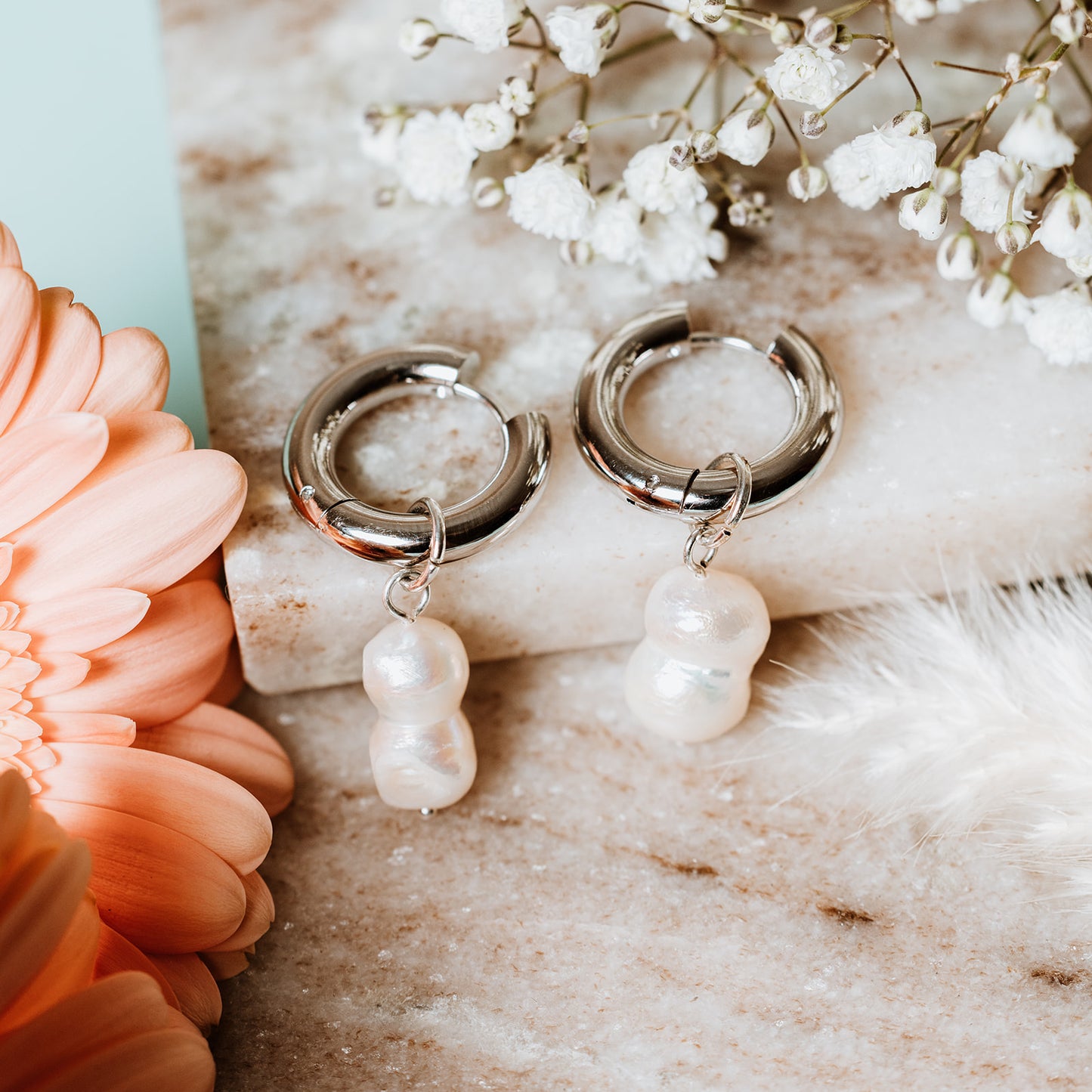 Chunky Hoops with Peanut Pearl, woman wearing Chunky Hoops with Peanut Pearl, peanut pearl, silver hoops, silver chunky hoops, silver earrings, pearl earrings.