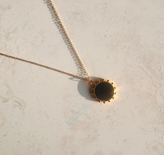 Gold necklace with black enamel sun pendant
