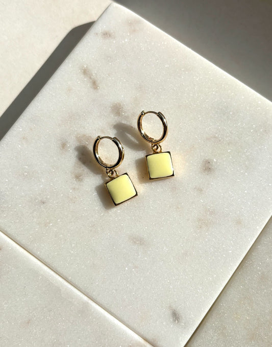 gold earrings, enamel earrings, hooped earrings, gold huggie earrings, yellow enamel earrings, woman wearing yellow gold square enamel earrings.