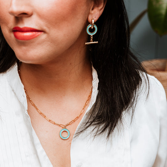 Paperclip chain with Enamel T Bar charm, woman wearing Paperclip chain with Enamel T Bar charm, enamel T-Bar, gold necklace, gold chain, gold charm. turquoise necklace, turquoise charm.