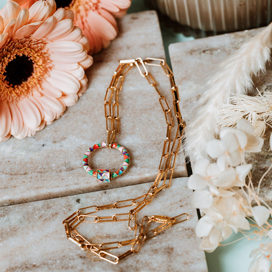 Gold paperclip chain, paperclip chain, enamel carabiner, enamel necklace, bright colour necklace, multicoloured charm, lady wearing gold paperclip necklace with multicoloured enamel carabiner charm