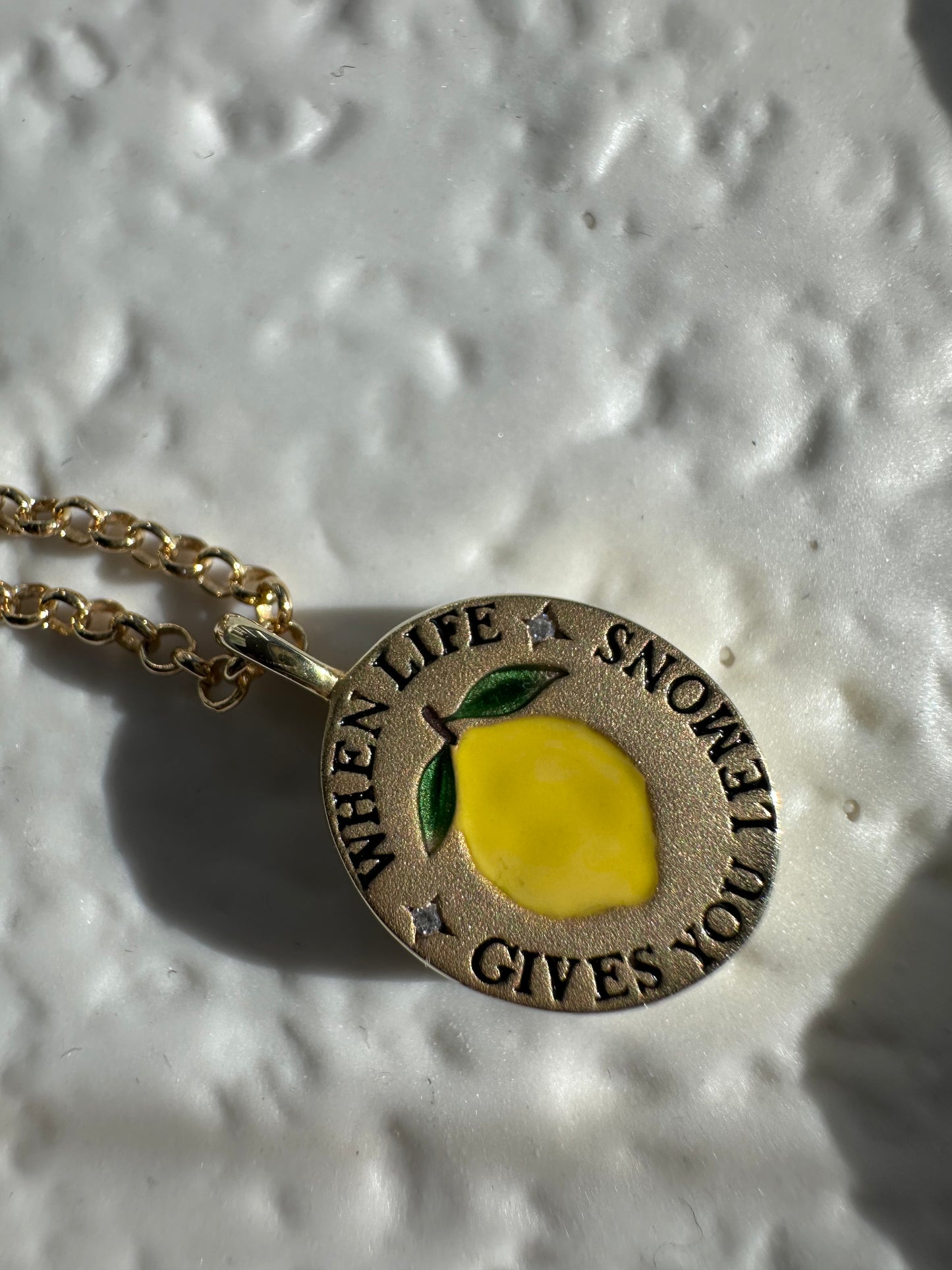 18k gold-plated pendant with ‘When Life Gives You Lemons’ engraved quote on delicate chain.
Close-up of gold-plated motivational pendant necklace with engraved quote.
'When Life Gives You Lemons’ engraved pendant necklace in gold-plated finish.