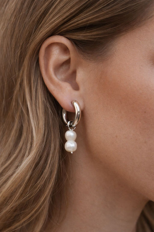Chunky Hoops with Peanut Pearl, woman wearing Chunky Hoops with Peanut Pearl, peanut pearl, silver hoops, silver chunky hoops, silver earrings, pearl earrings.