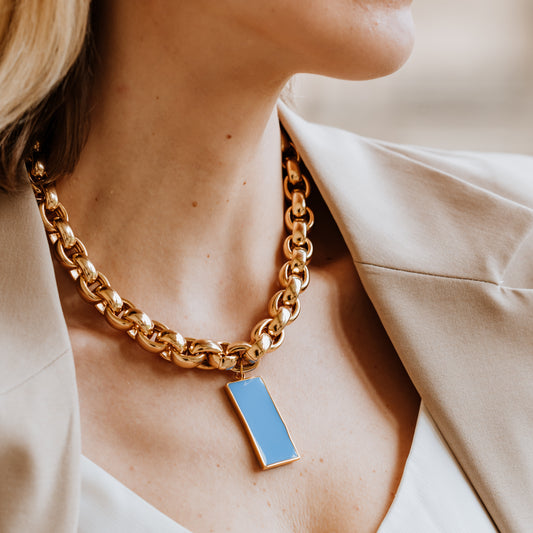 Gold chain necklace with a blue enamel pendant . As seen in vogue and tatler , london fashion week 