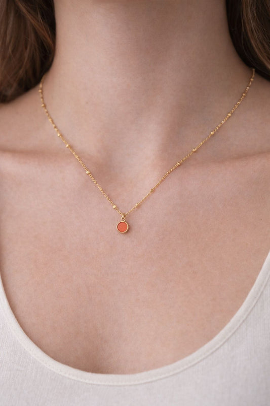 Gold satellite necklace with red enamel dot charm