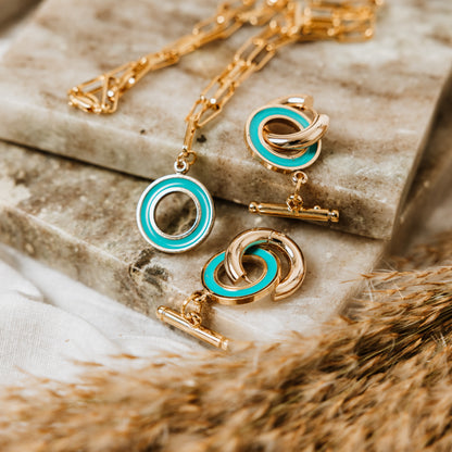 Paperclip chain with Enamel T Bar charm, woman wearing Paperclip chain with Enamel T Bar charm, enamel T-Bar, gold necklace, gold chain, gold charm. turquoise necklace, turquoise charm.