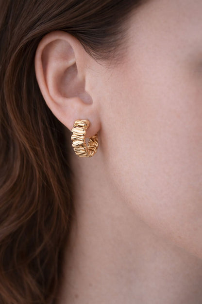 Woman wearing Rippled Gold Hoop Earrings, Rippled Gold Hoop Earrings, gold hoops, gold earrings, rippled earrings, rippled hoops.