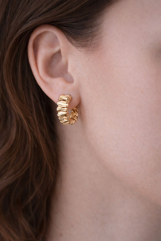 Woman wearing Rippled Gold Hoop Earrings, Rippled Gold Hoop Earrings, gold hoops, gold earrings, rippled earrings, rippled hoops.