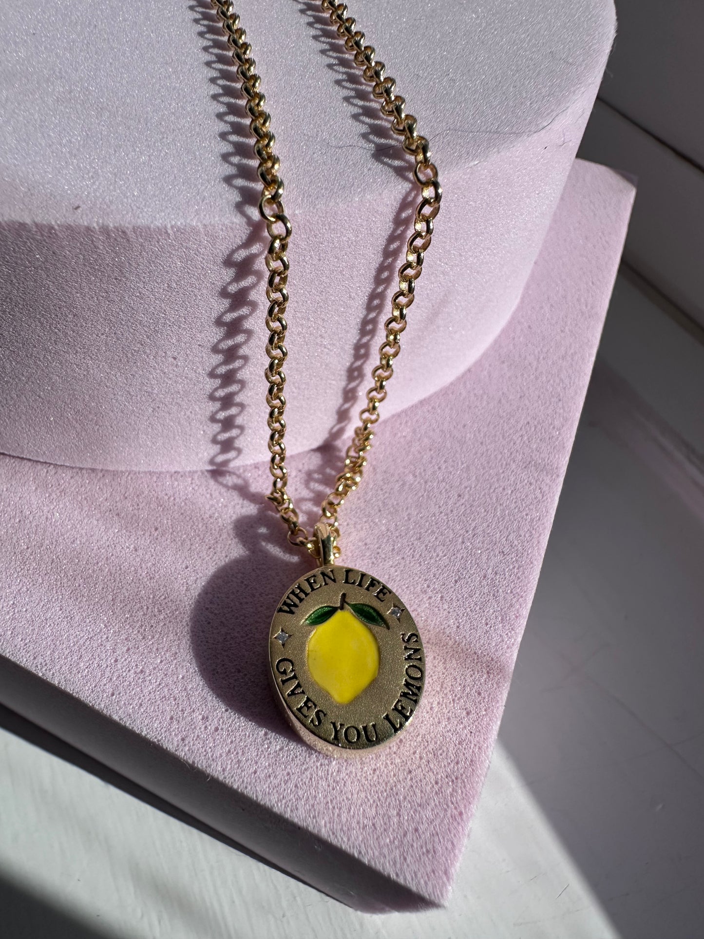 18k gold-plated pendant with ‘When Life Gives You Lemons’ engraved quote on delicate chain.
Close-up of gold-plated motivational pendant necklace with engraved quote.
'When Life Gives You Lemons’ engraved pendant necklace in gold-plated finish.