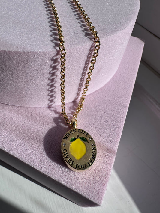 18k gold-plated pendant with ‘When Life Gives You Lemons’ engraved quote on delicate chain.
Close-up of gold-plated motivational pendant necklace with engraved quote.
'When Life Gives You Lemons’ engraved pendant necklace in gold-plated finish.