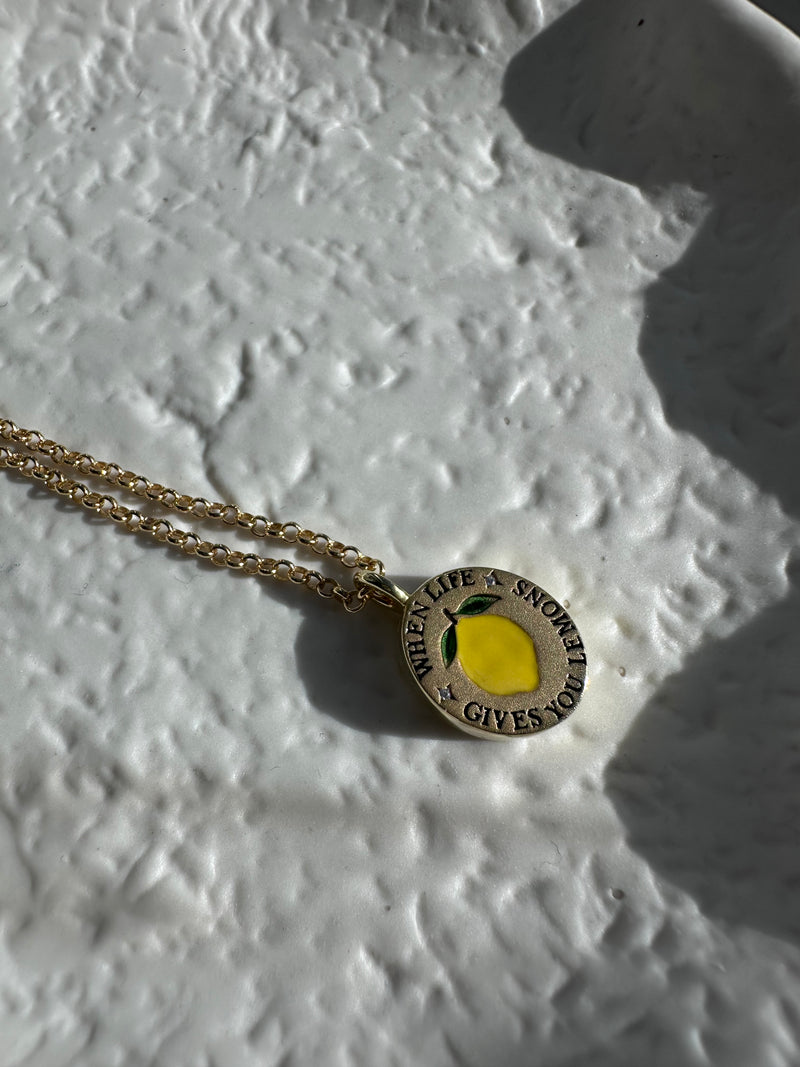 18k gold-plated pendant with ‘When Life Gives You Lemons’ engraved quote on delicate chain.
Close-up of gold-plated motivational pendant necklace with engraved quote.
'When Life Gives You Lemons’ engraved pendant necklace in gold-plated finish.